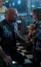 She refused to sit down in the diner booth, but when the tattooed biker saw what was strapped to her back, the entire restaurant froze