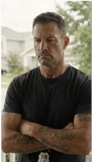 A fake cop storms up to a homeowner and threatens to put him in cuffs over an HOA fine, while the smug HOA president watches from behind